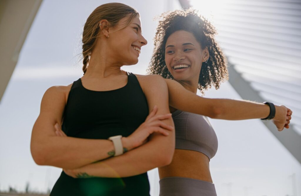 happy women smiling and looking at each other