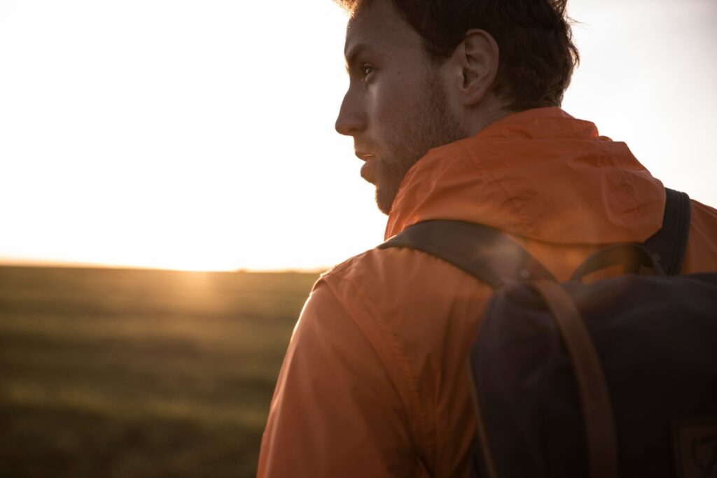 man hiking on trail at sunrise
