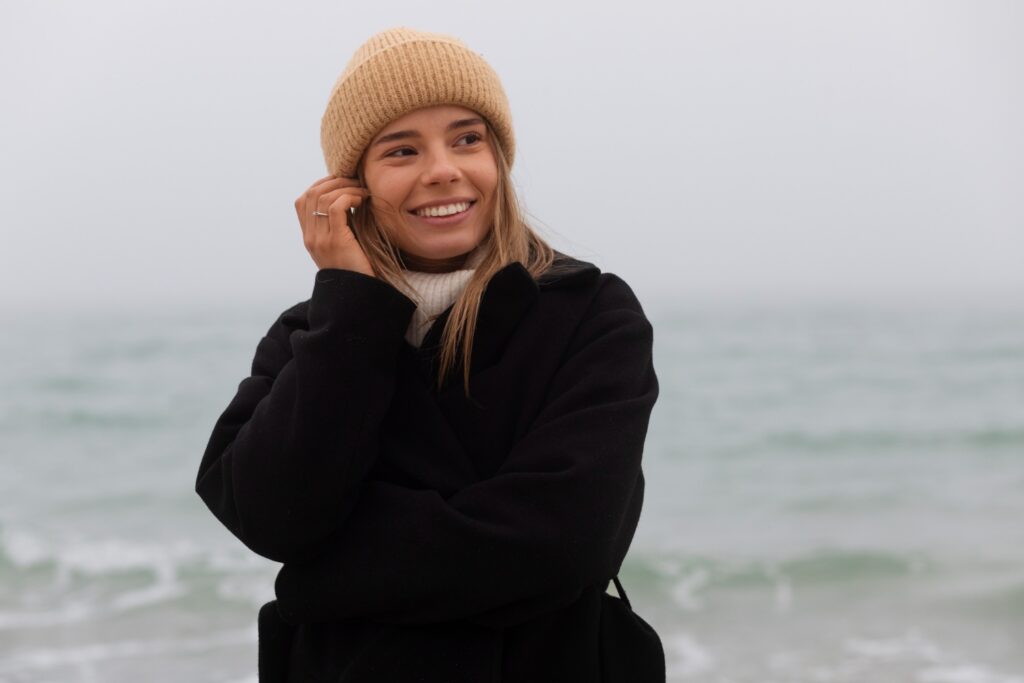 smiling woman standing near water