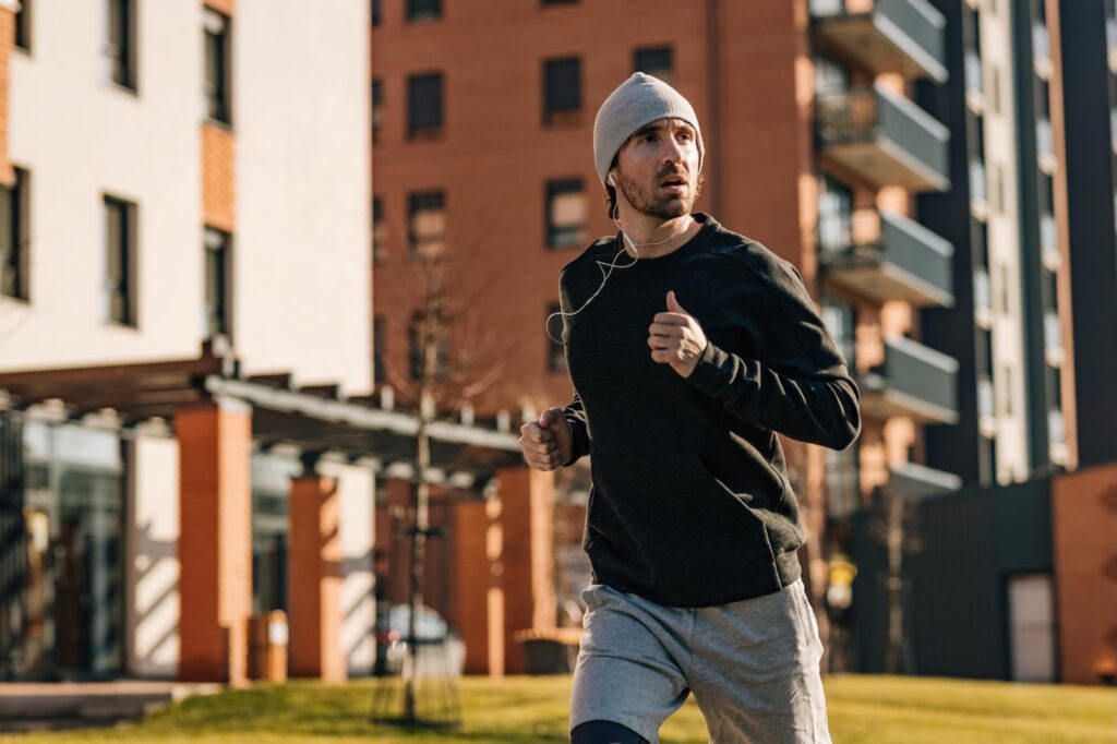 man wearing hat while running