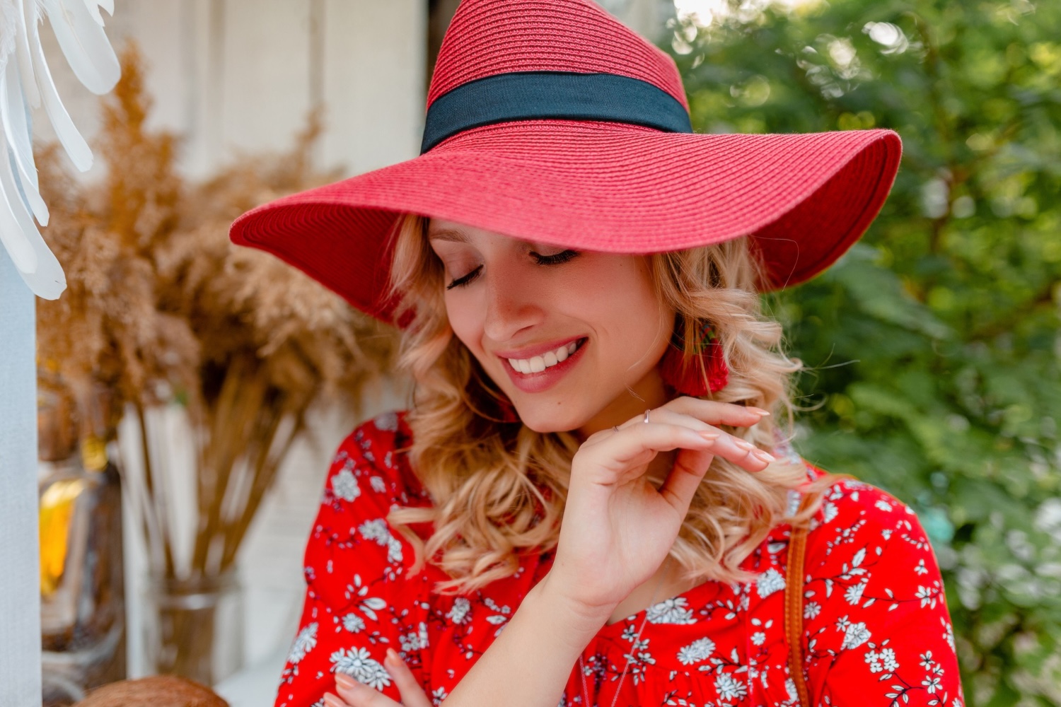 woman wearing sun hat after hair transplant procedure